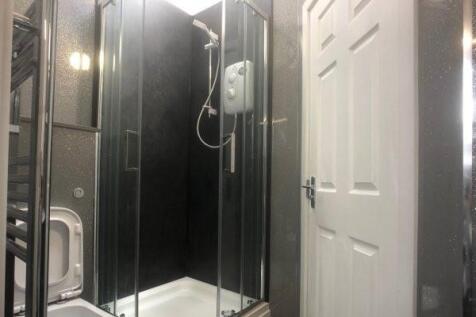 A clean and modern bathroom with a shower enclo...
