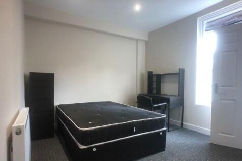 A spacious master bedroom featuring a double be...