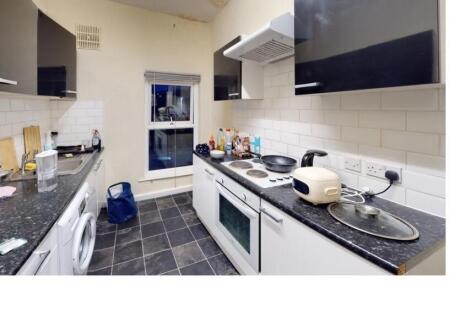 A bright and modern kitchen with ample counter ...