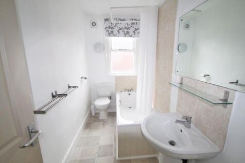 A bright, well-maintained bathroom featuring a ...
