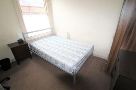 A bright and clean single bedroom featuring a c...