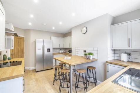 Bright and modern kitchen featuring a large cen...