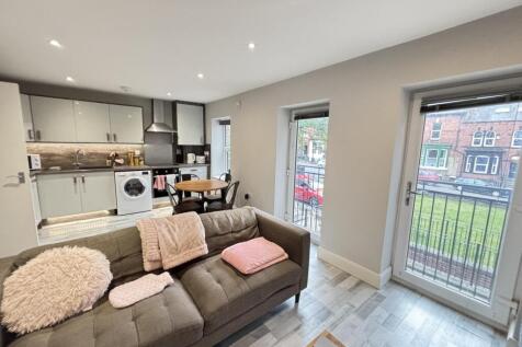 A bright and modern living room with ample natu...