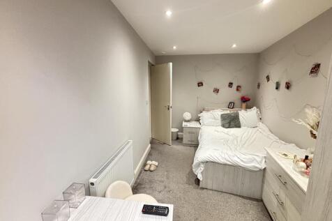 A well-maintained bedroom featuring a double be...