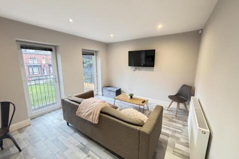 Bright and modern living room featuring a comfo...