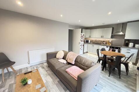 A bright and welcoming living room featuring mo...