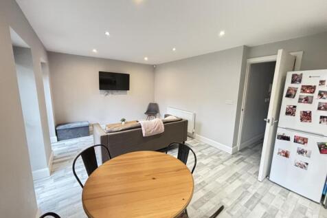 A bright and modern living room featuring ample...