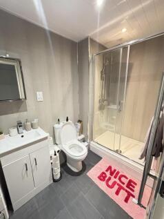A clean and modern bathroom with a spacious sho...