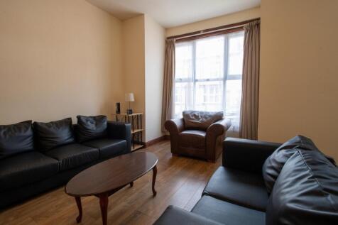 A spacious and cozy living room with comfortabl...