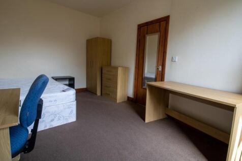 A well-maintained bedroom featuring a single be...