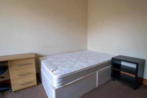 A modest single bedroom featuring a single bed ...