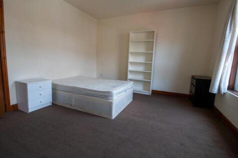 A spacious and well-maintained bedroom featurin...