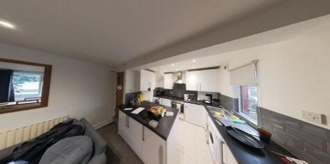 A modern kitchen featuring ample workspace, wel...