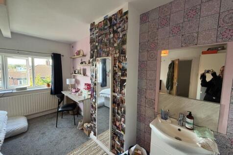 A cozy bedroom featuring a large window that al...