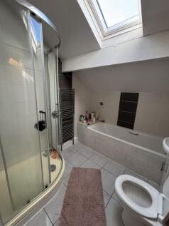 A modern bathroom featuring a large shower encl...