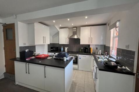 A modern, well-lit kitchen with ample workspace...