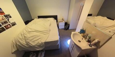 A bright and cozy bedroom featuring a double be...