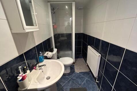 A modern bathroom featuring a shower enclosure,...