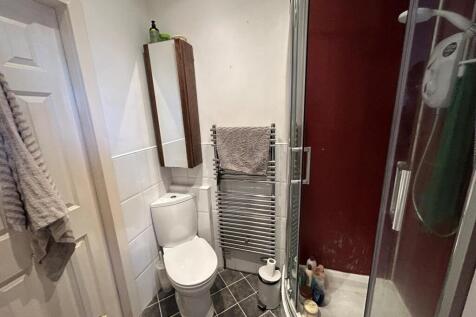 A clean and modern bathroom with a large bath, ...