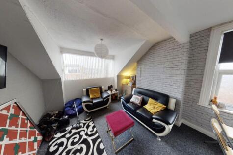 Bright and modern living room featuring a comfo...