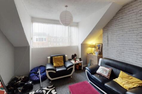 A modern, well-lit living room featuring contem...