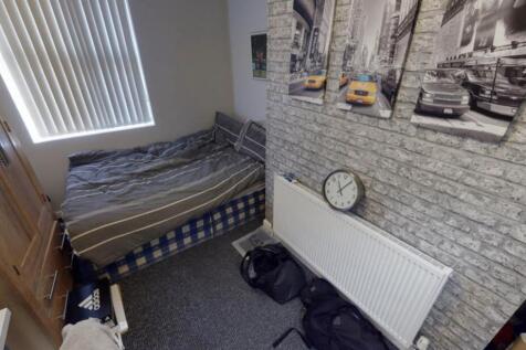 A cozy bedroom featuring a large bed and a bric...