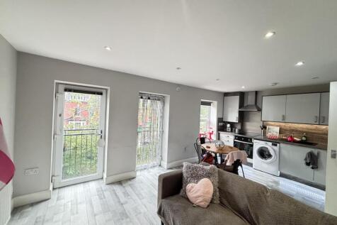 A bright and spacious living room featuring lar...