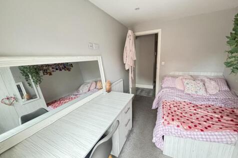 A bright and welcoming bedroom featuring a doub...