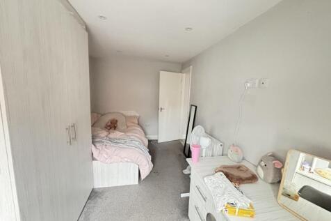 A spacious and inviting bedroom featuring a dou...