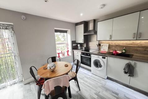 A modern, well-lit kitchen featuring ample work...