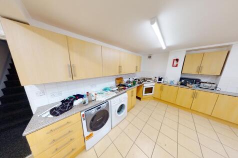 Bright, modern fitted kitchen with tiled floor,...