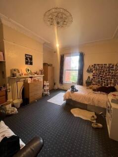 A spacious and well-lit master bedroom featurin...