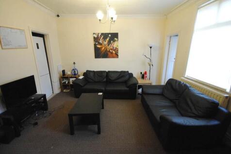 A well-lit, spacious living room featuring two ...