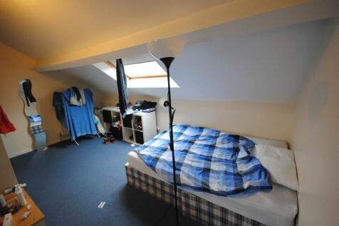 A comfortable double bedroom featuring a neatly...