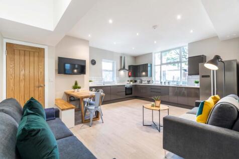 A spacious, modern living room featuring large ...