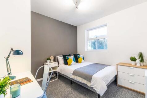 A bright and spacious master bedroom featuring ...