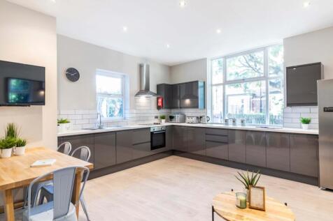 Bright and modern living room featuring large w...