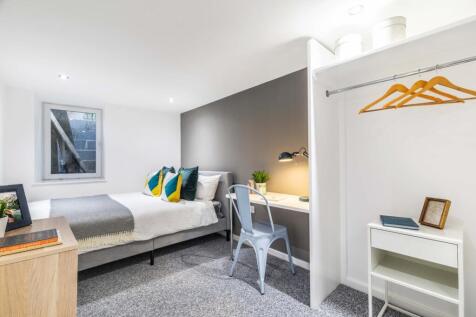 A bright, well-maintained bedroom featuring a c...