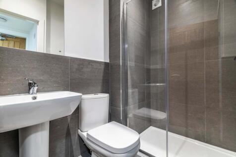A clean and modern bathroom with a large shower...