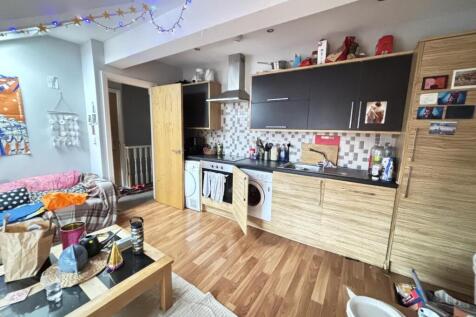 A spacious, modern living room with ample natur...