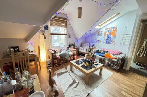 A bright and inviting living room with large wi...