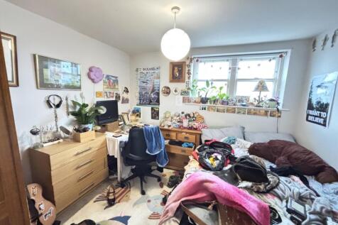 A lived-in living room with natural light comin...