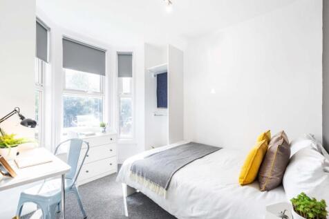 Bright and inviting bedroom featuring a large b...