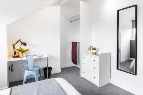 A bright and neatly maintained bedroom featurin...