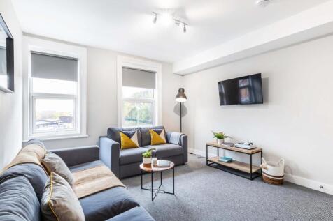 Bright and spacious living room featuring comfo...