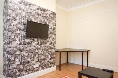 A well-maintained living room featuring a strik...