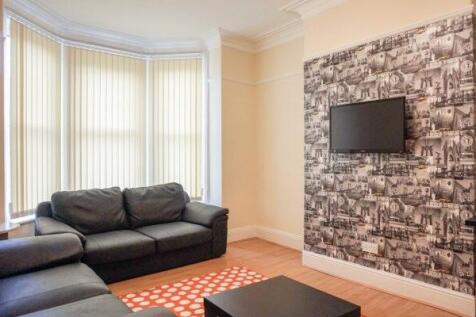 A bright and inviting living room featuring com...