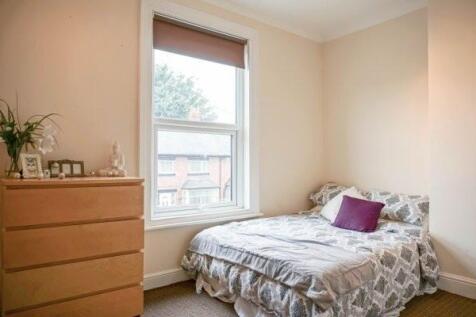 A cozy, well-maintained bedroom with a large wi...