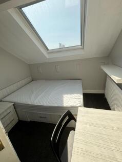 A small, bright bathroom with a well-lit window...