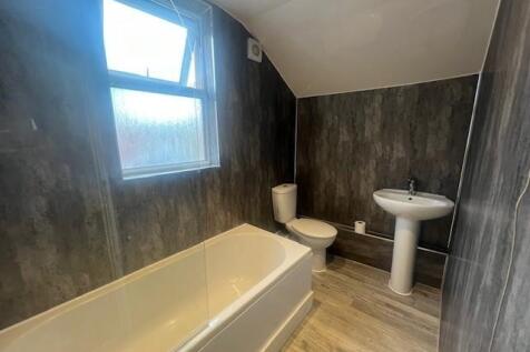 Modern bathroom with a fitted bath, white pedes...